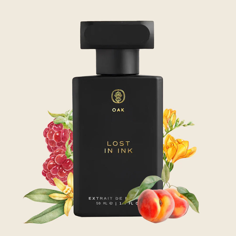 a bottle of lost in ink next to a bunch of flowers